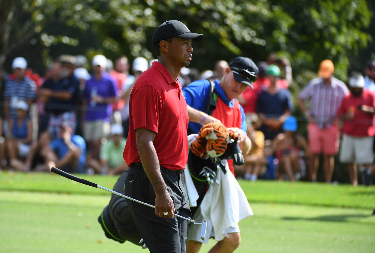 Tiger Woods approaches East Lake's fifth green with caddie Joe LaCava.