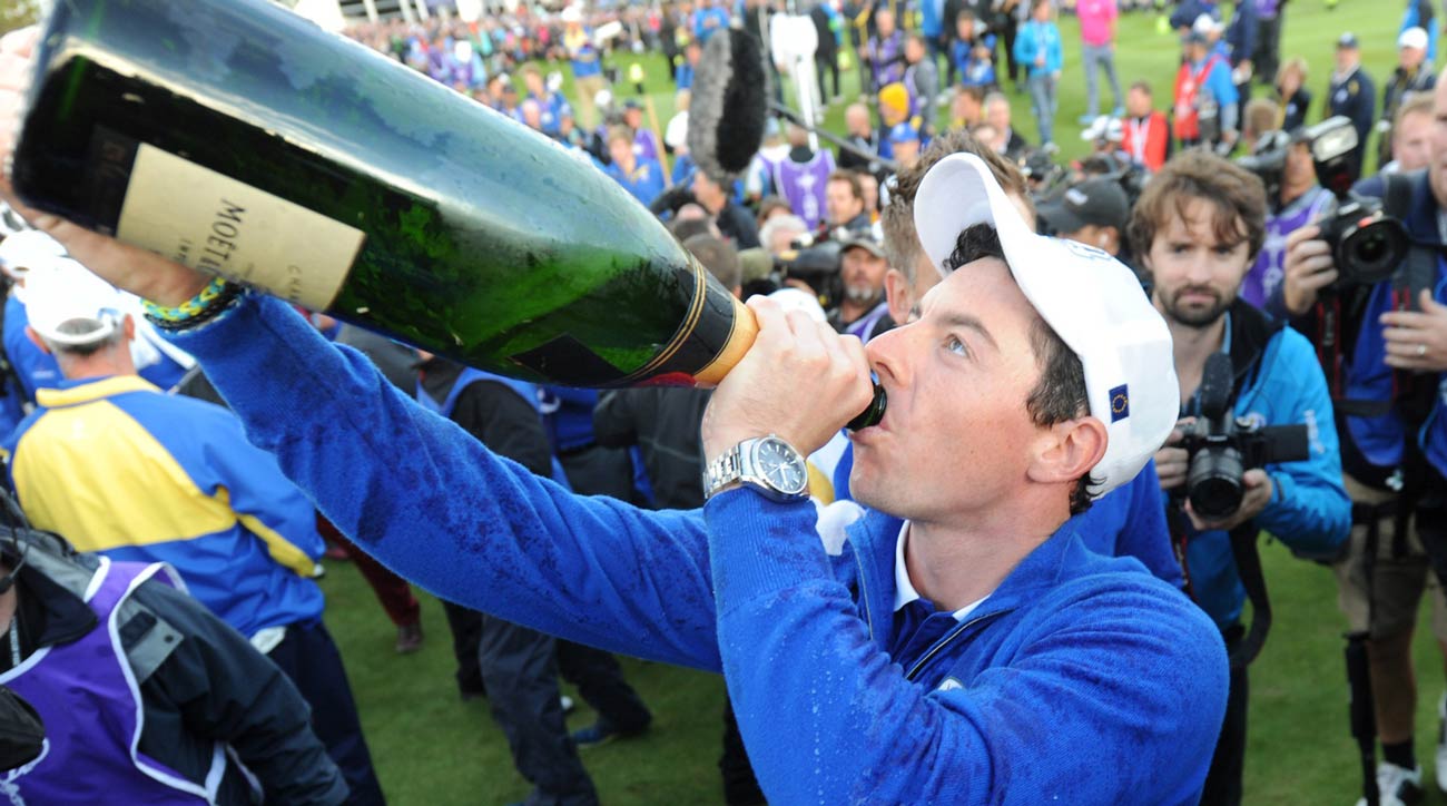 Rory McIlroy enjoys a large bottle of champagne to celebrate
