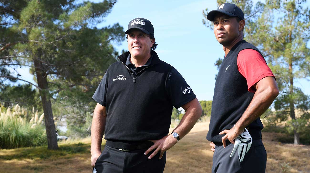 Phil Mickelson and Tiger Woods look on during The Match on Friday at Shadow Creek.