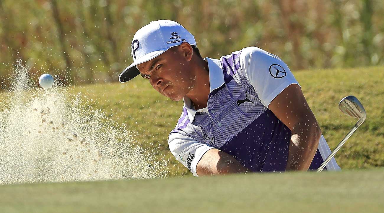 Rickie Fowler hits out of a bunker.
