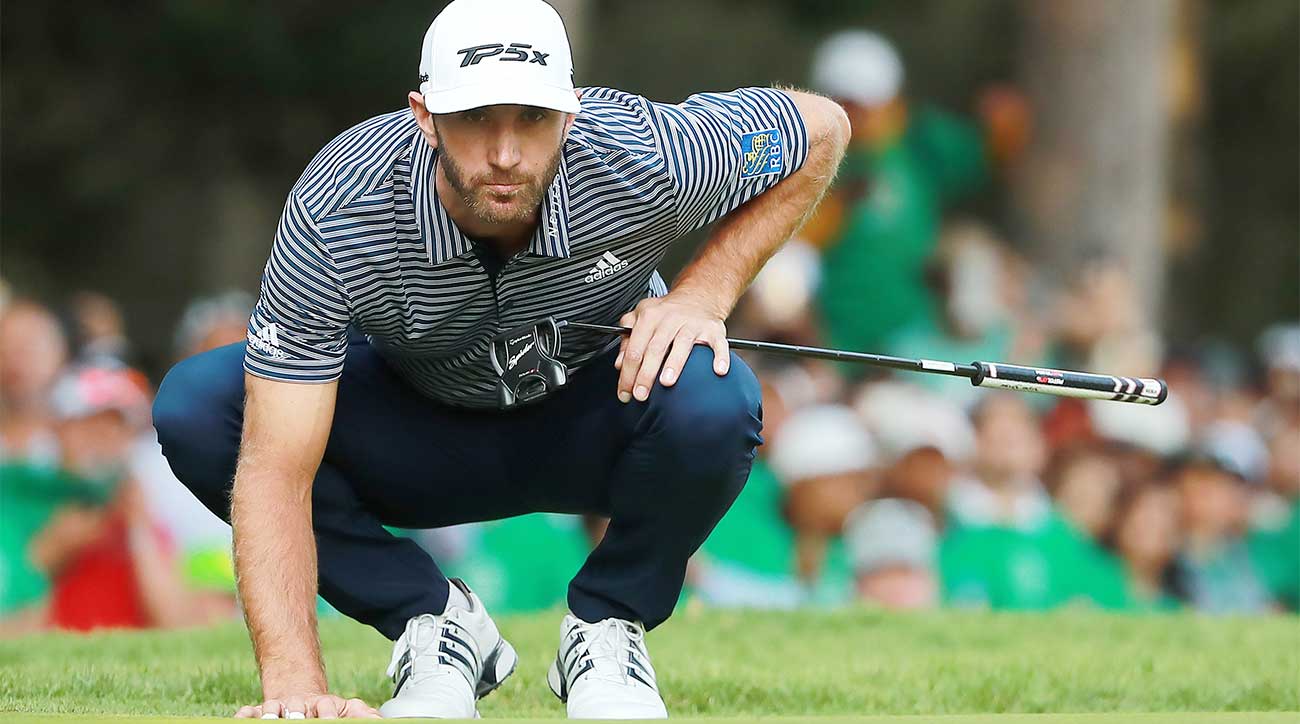 Dustin Johnson reads a putt at the WGC-Mexico Championship holding his TaylorMade Spider Tour Black putter.