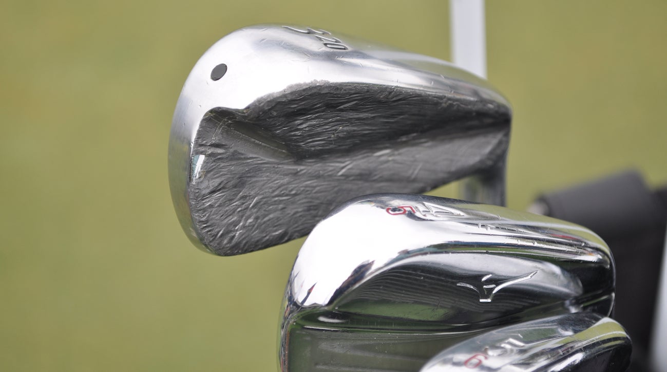 Vijay Singh's Srixon U65 utility iron is almost unrecognizable due to a ridiculous amount of lead tape. The red number stamped on his Mizuno MP-5 is due to the weaker loft he employs on each iron to reduce offset. 